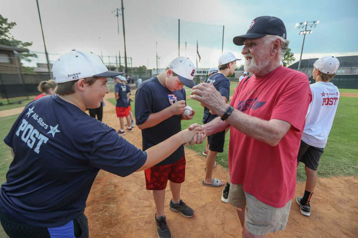 Post Oak Little League team Andrew Stover (left) shakes hand with fan Chuck Facciponte as Justin Michaelis (center) signs his ball in advanced to the Little League World Series on Thursday, Aug. 9, in Houston.