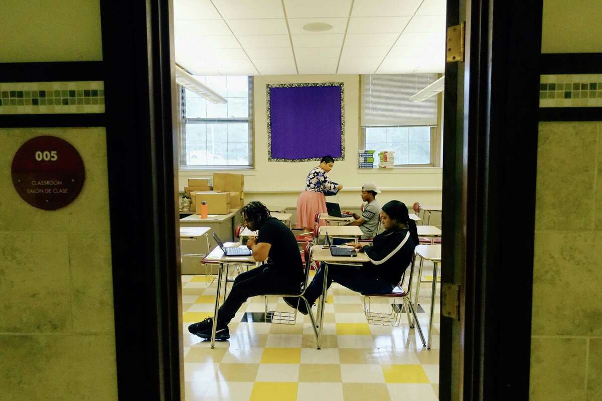 APEX teacher Ruth Chapple guides students, from left to right, Yanmarcos Gonzalez, Frank Martinez, and Davmoni Cintron as they work on APEX online courses at Hackett Middle School on Monday, Aug. 13, 2018, in Albany, N.Y. (Paul Buckowski/Times Union)