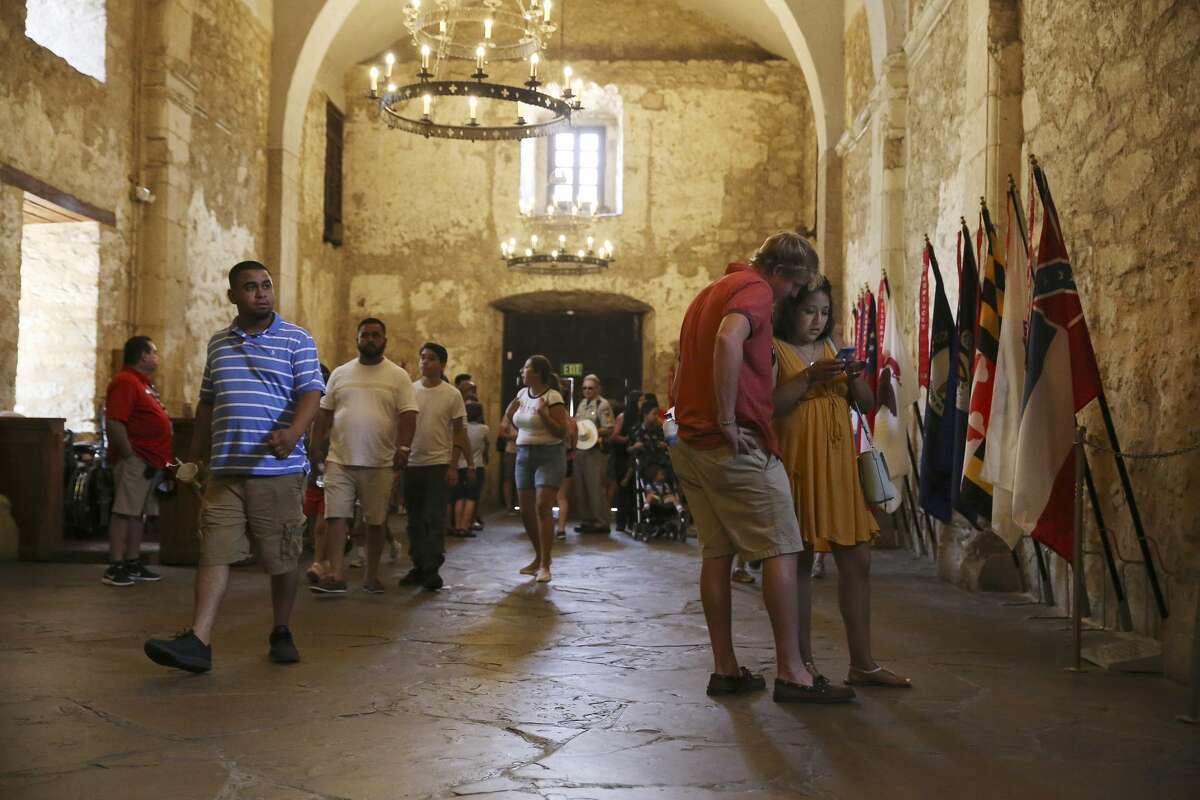 On the right, Chandler Harris, 23, and Abigail Esquivias, 22, of Long Island, New York, tour the Alamo, Tuesday, August 7, 2018. Conservation efforts are underway in order to slow the progression of the deterioration.