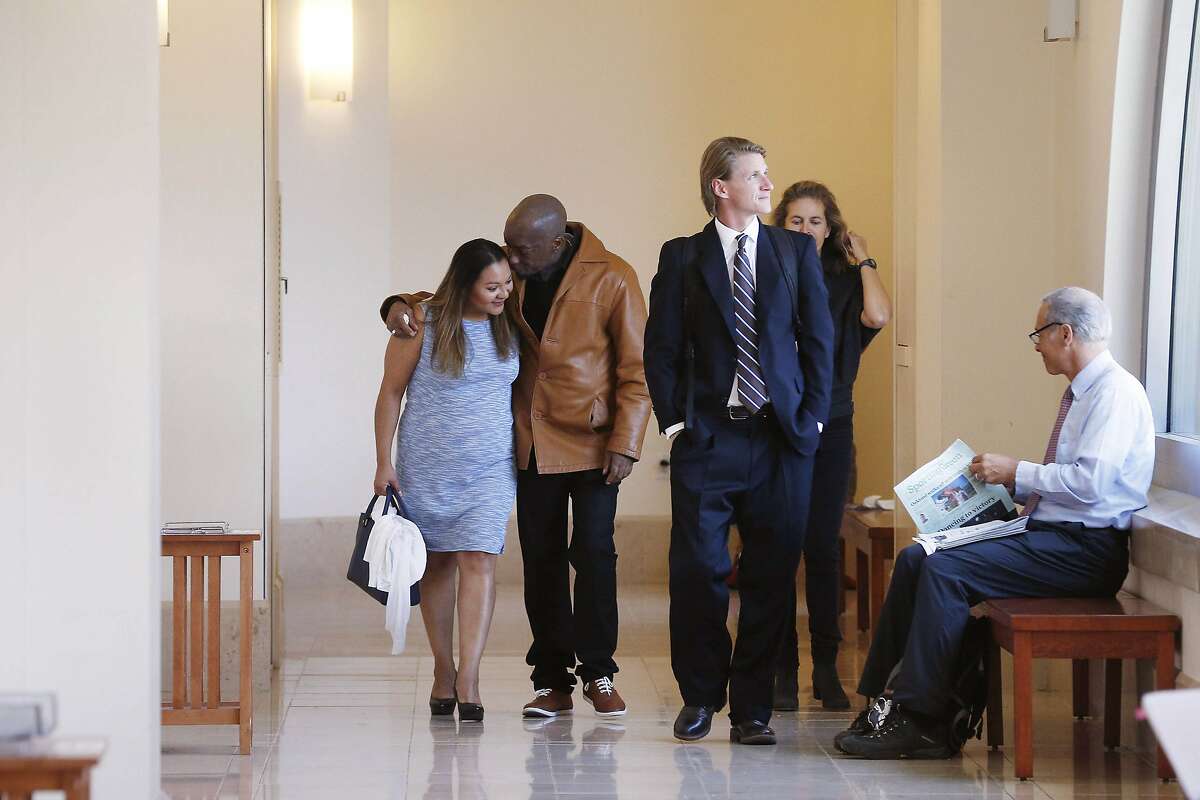 Dewayne Johnson (second from left), former groundskeeper for the Benicia Unified School District, walks with his wife Araceli Johnson (left) through Superior Court of California as they return to Department 504 during the Monsanto trial on Monday, July 23, 2018 in San Francisco, Calif.