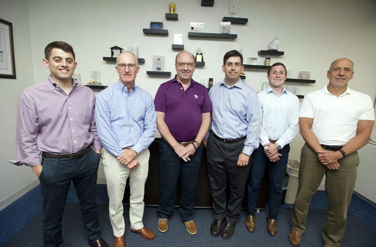 Olympus Partners, from left, vice president Sam Greenberg, managing partner James Conroy, managing partner Rob Morris, partner Evan Eason, vice president Robert Polakoff and managing partner Louis Mischianti pose for a photo inside the Olympus Partners office at One Station Place in Stamford, Conn. on Monday, Aug. 13, 2018.