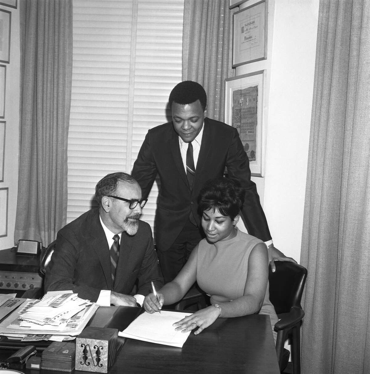 Soul singer Aretha Franklin signs her contract with Atlantic Records (L-R Jerry Wexler, husband and manager Ted White and Aretha franklin) on November 21, 1966 in New York City.