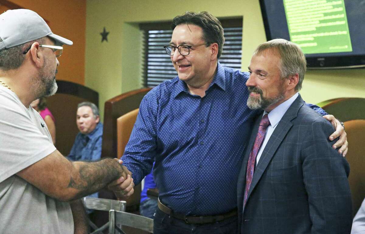 Former U.S. Rep. Pete Gallego shakes hands with campaign strategist Christian Archer at his side as he meets with his supporters at an election night party the Taqueria Mexico restaurant on Somerset Rd. on July 31, 2018.