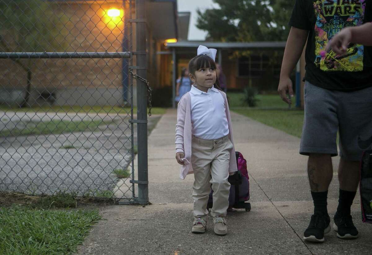 Alyson Zamarripa walks with her father Joe Zamarripa and grandmother Nora Leal on Alyson's first day of pre-kindergarten at Democracy Prep at the Stewart Campus Aug. 13, 2018. The school is run by the New York-based Democracy Prep charter network while remaining an SAISD school.
