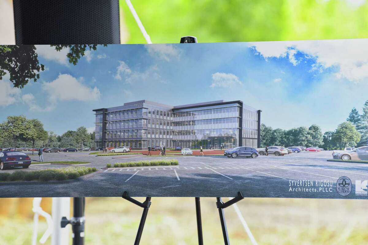 An artist's rendition of what the new Ayco headquarters will look like is seen on display during a groundbreaking ceremony for the building at the site of the former Starlite theater and Colonie Coliseum on Monday, Aug. 13, 2018, in Colonie, N.Y. (Paul Buckowski/Times Union)