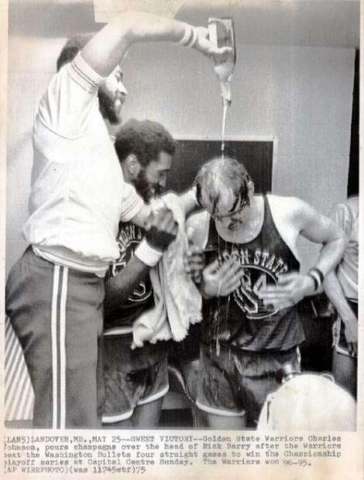 May 25, 1975: Insert your own Dr. Rosanelli joke here. Warrior Charles Johnson pours champagne on Rick Barry after the four-game sweep over the Washington Bullets. Even though the team was no longer the San Francisco Warriors, and their regular season games were played in Oakland, the playoff games took place in the Cow Palace. There was also a huge public victory celebration that took place in Union Square.
