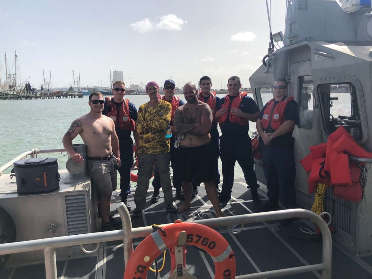 Coast Guard crews rescued three men, in foreground, after their 24-foot vessel capsized near Galveston on Monday, Aug. 13, 2018.