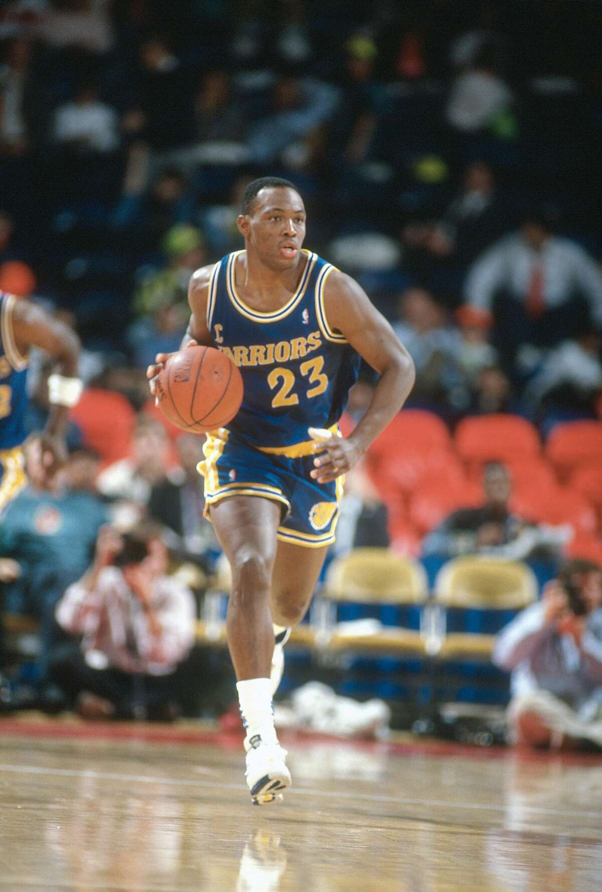 LANDOVER, MD - CIRCA 1990: Mitch Richmond #23 of the Golden State Warriors dribbles the ball up court against the Washington Bullets during an NBA basketball game circa 1990 at the Capital Centre in Landover, Maryland. Richmond played for the Warriors from 1988-91.