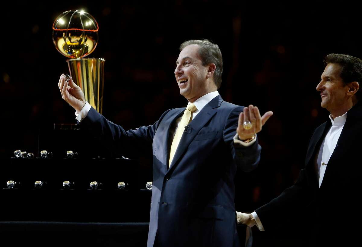 Golden State Warriors' owners Joe Lacob (left) and Peter Guber enjoy handing out 2015 NBA Championship rings before Warriors played the New Orleans Pelicans during NBA game at Oracle Arena in Oakland, Calif., on Tuesday, October 27, 2015.