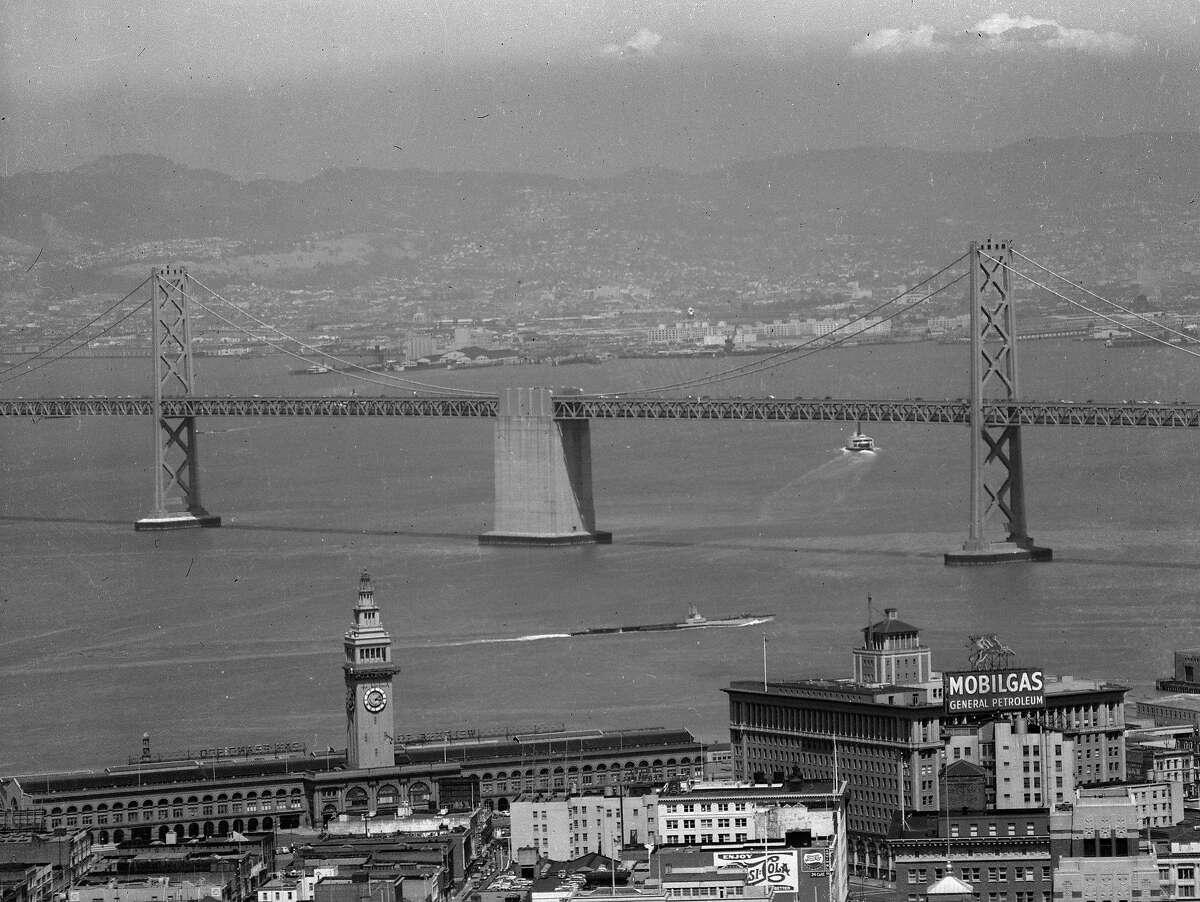 Aerial shot of the San Francisco Waterfront and Harbor looking east, with the Ferry Building in the foreground and Bay Bridge behind it December 6, 1947 From Negatives, Photographer Unknown