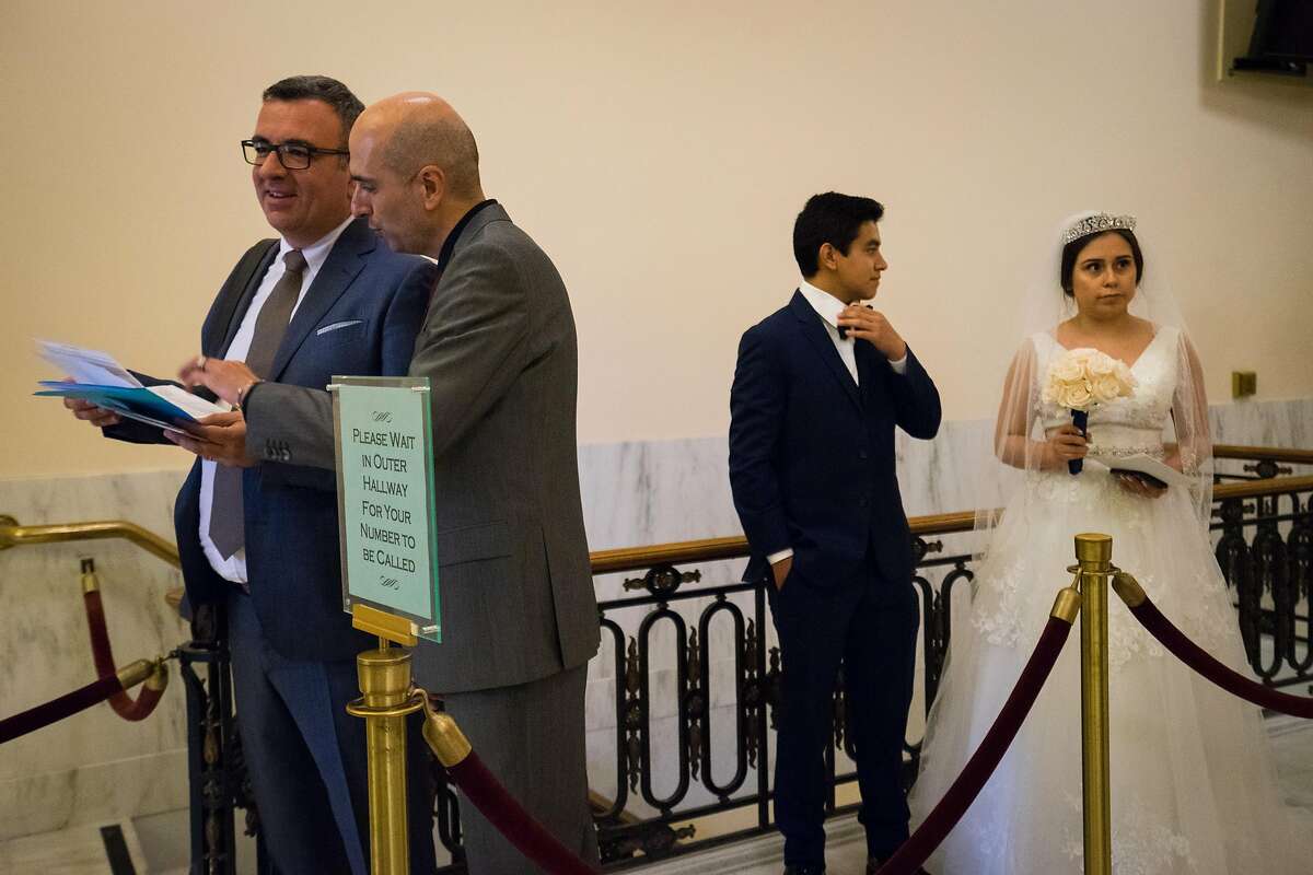 (left to right) Engaged couples, Xavier and Josep Garcia-Weibel and Bella Reynoso, 19, and Alex Garcia, 18, wait in line to be married at City Hall in San Francisco, Calif. on Monday, August 13, 2018.