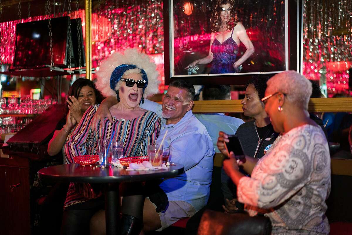 Dan Correa (center) laughs while Collette LeGrande sits on his lap during a performance at The Hot Boxxx Girls Drag Show in the Tenderloin neighborhood of San Francisco, Calif. on Saturday, August 11, 2018.