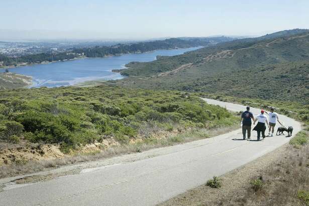 twocents29c-c-15sep02-go-ss hikers walk along a paved road that