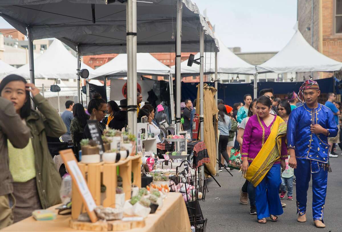 Dozens of people walk past a variety of vendors during the Undiscovered Creative Night Market hosted by SOMA Pilipinas in the South of Market district of San Francisco, Calif. Saturday, July 21, 2018.