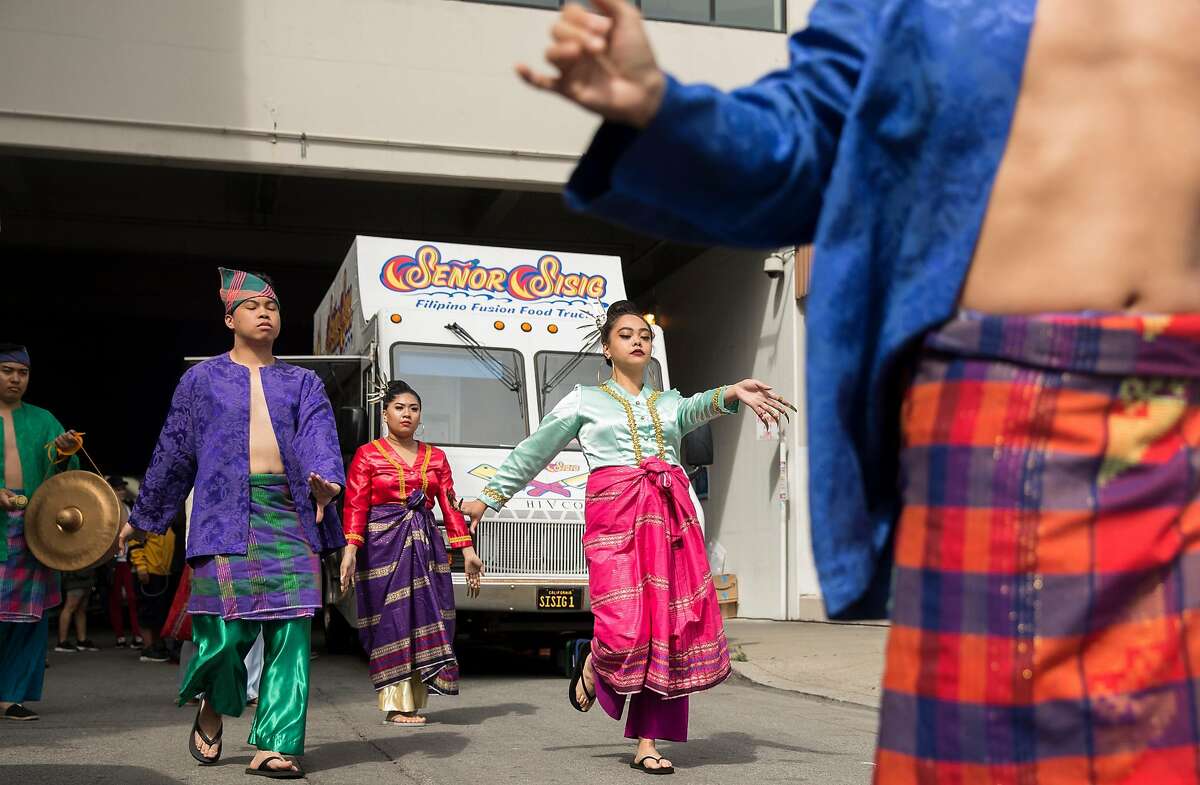 Dancers perform a traditional Filipino Pangalay during the opening parade for Undiscovered Creative Night Market hosted by SOMA Pilipinas in the South of Market district of San Francisco, Calif. Saturday, July 21, 2018.