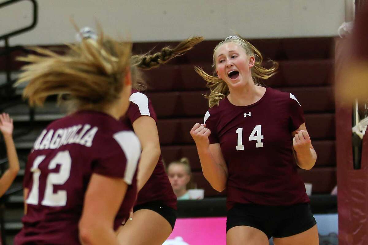 Magnolia's Ellie Anderson (14) celebrates with teammates during the volleyball game against Klein Collins on Tuesday, Aug. 14, 2018, at Magnolia High School.