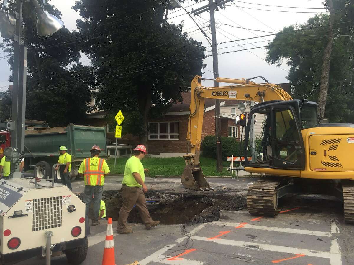 Work crews were on the scene of a sinkhole Wednesday that opened Tuesday at the intersection of Washington and North Main avenues. Despite the damage, Washington Avenue was open and traffic was flowing.