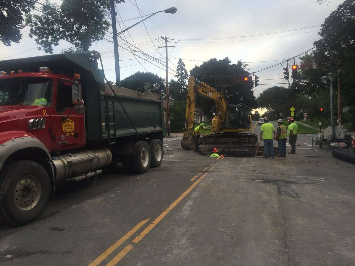 Work crews were on the scene of a sinkhole Wednesday that opened Tuesday at the intersection of Washington and North Main avenues. Despite the damage, Washington Avenue was open and traffic was flowing.
