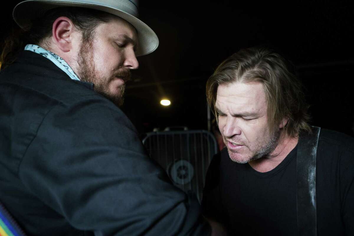 Ben Dickey, left, and Jack Ingram, right, warm up in Houston before their performance of an acoustic set of songs from the film "Blaze" which is about musician Blaze Foley.
