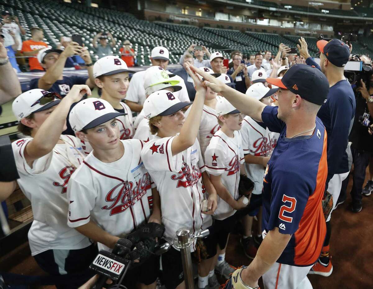 Houston Astros Carlos Correa and Alex Bregman greet members of the Post Oak Little League before they head to the Little League World Series during batting practice before the start of an MLB game at Minute Maid Park, Friday, August 10, 2018, in Houston.