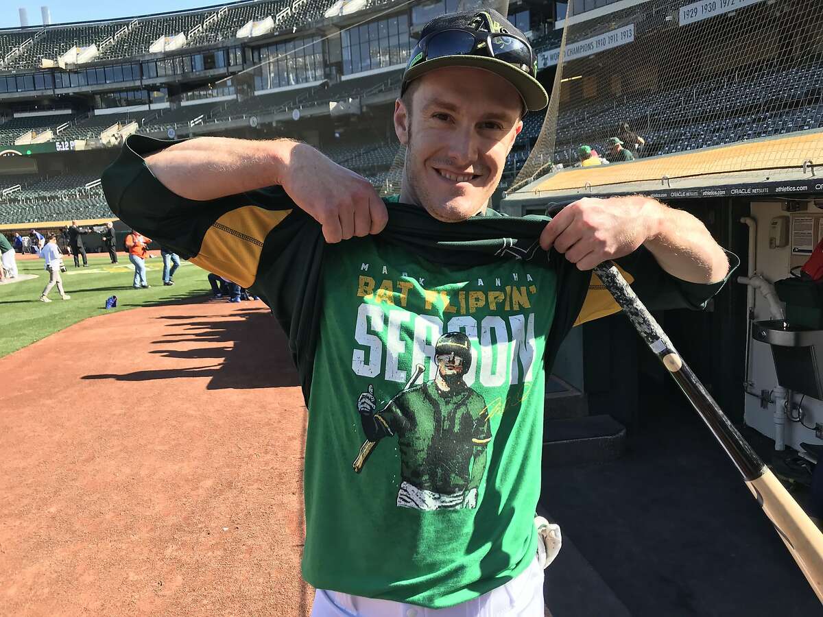 Mark Canha of the Oakland Athletics shows off his "Bat-flipping season" t-shirt before the A's faced the Toronto Blue Jays at Oakland Coliseum on Monday July 30, 2018.