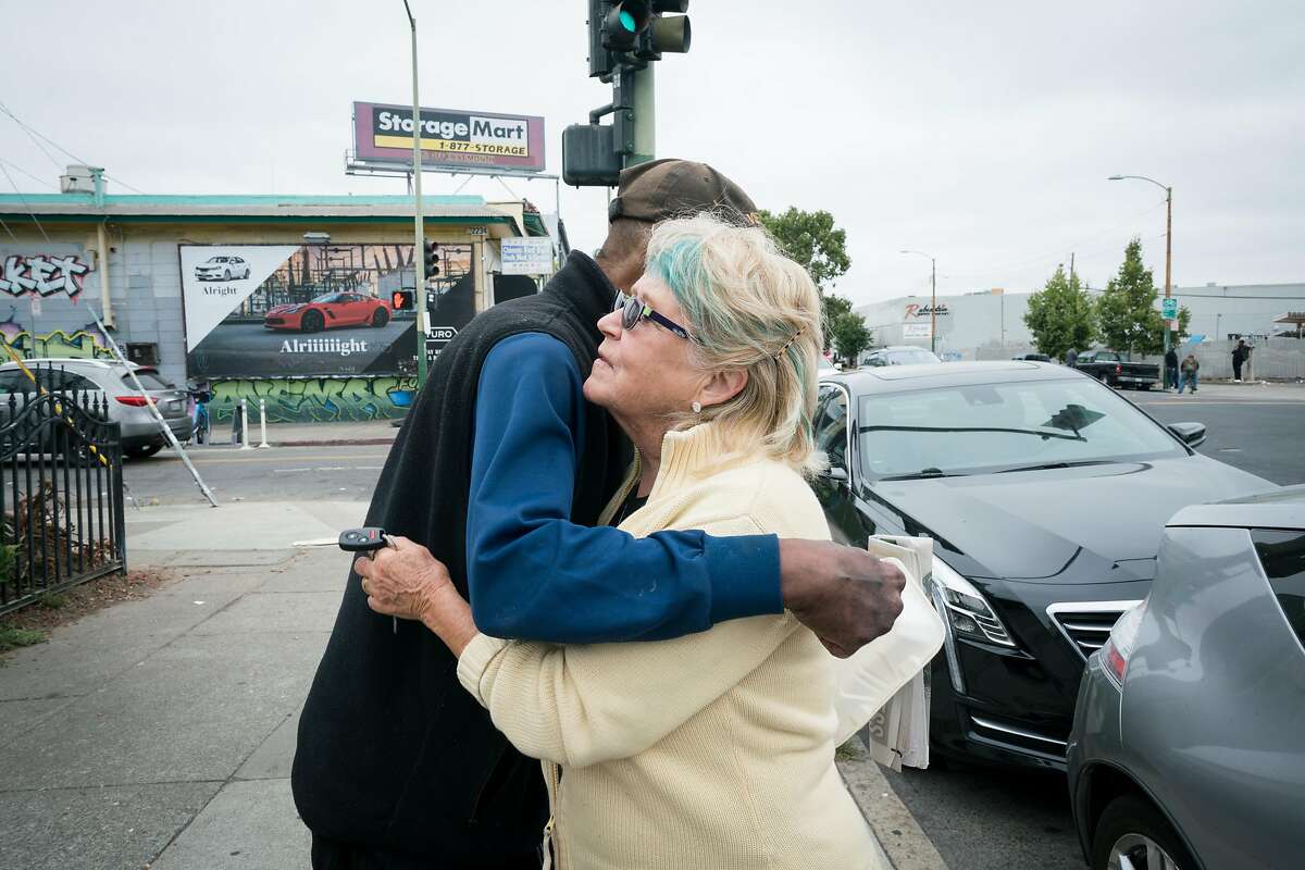 Eddie Smith (left) and Maryly Snow part ways with a hug in Oakland, Calif. on Tuesday, August 14, 2018.