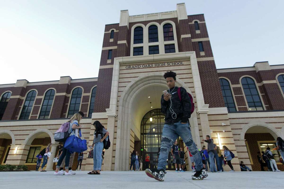Grand Oaks High School students wait outside on the first day of school on Wednesday, Aug. 15, 2018, in Spring.
