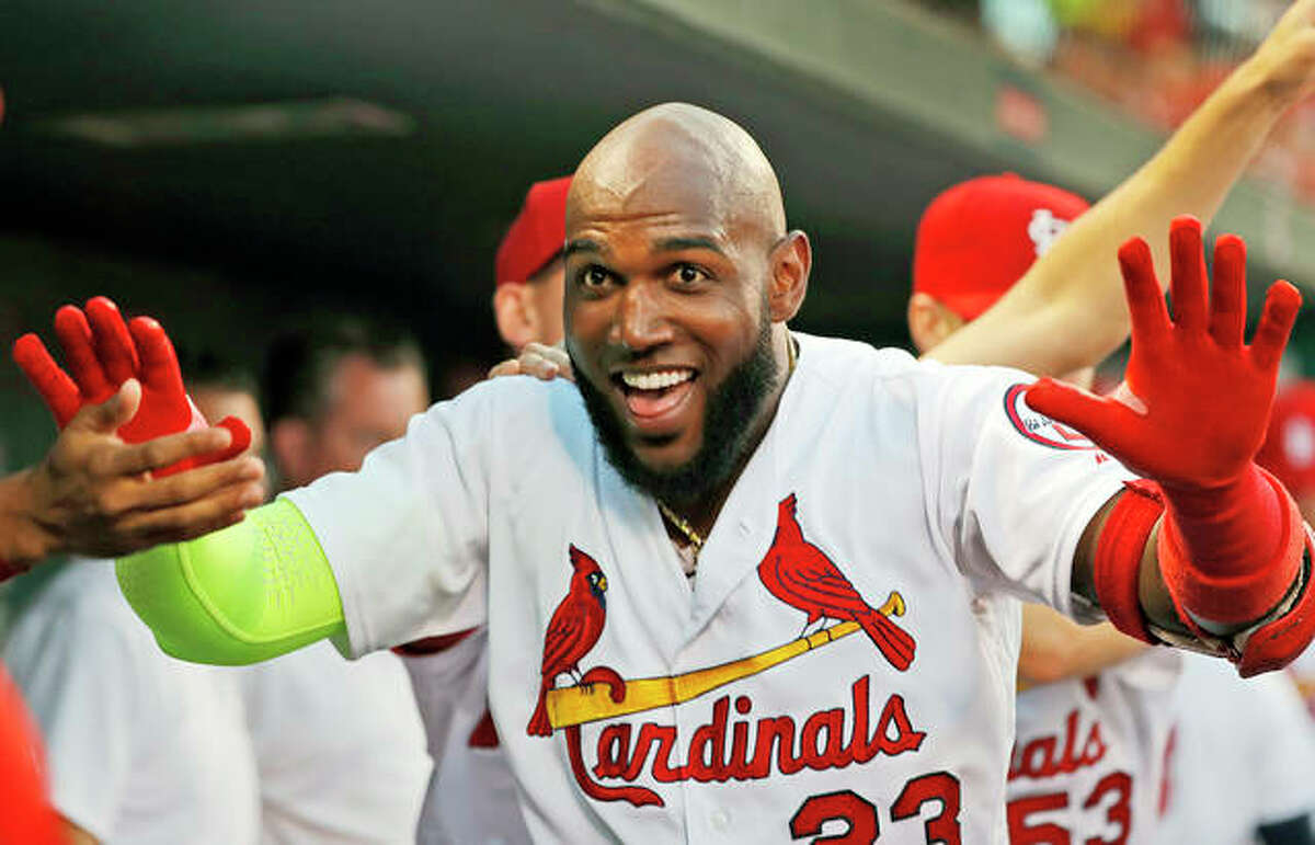 The Cardinals’ Marcell Ozuna is congratulated by teammates after hitting a solo home run in the second inning of Wednesday night’s game against the Washington Nationals in St. Louis.