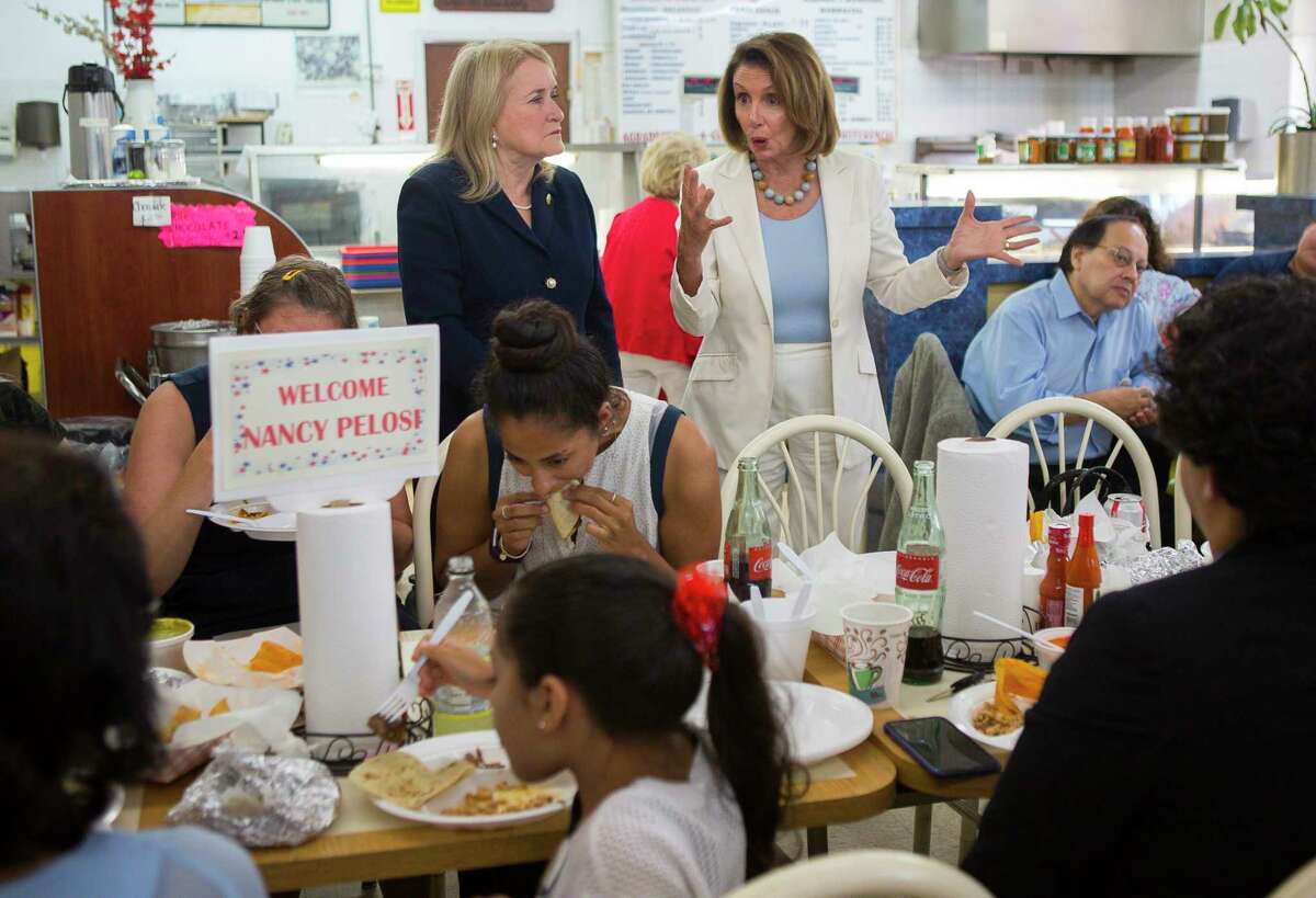 House Democratic leader Nancy Pelosi and congressional candidate Sylvia Garcia talk about issues facing voters this fall with a group of people eating at Gerardo's on Patton Street, Wednesday, Aug. 15, 2018 in Houston.
