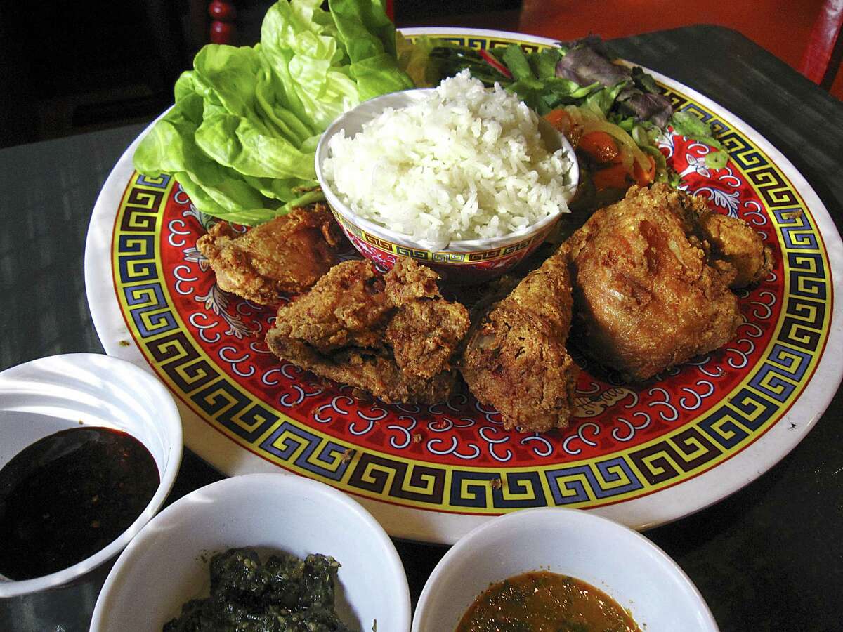 Thai fried chicken with rice, pickles, Bibb lettuce and sauces from Hot Joy.