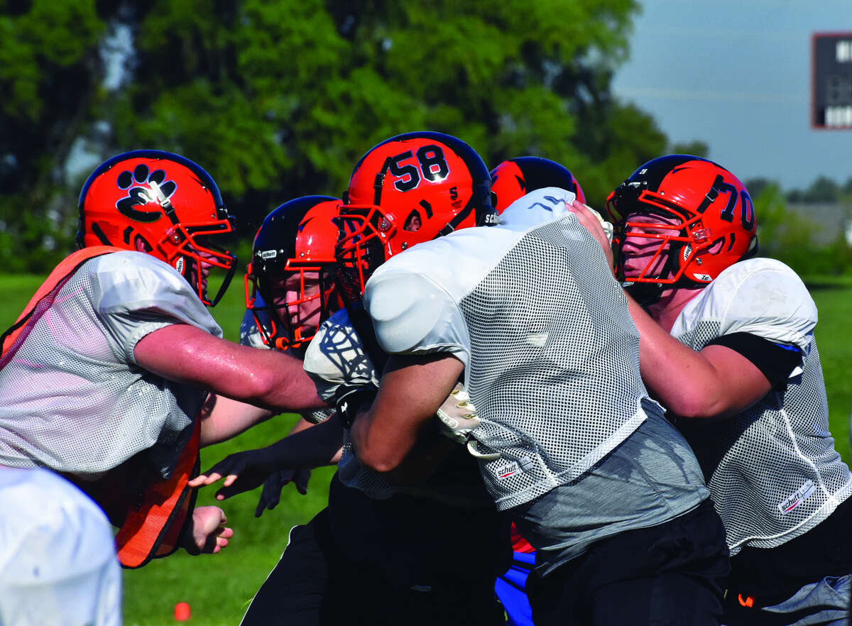 Members of the Edwardsville offensive and defensive lines battle each other during a practice at the District 7 Sports Complex.