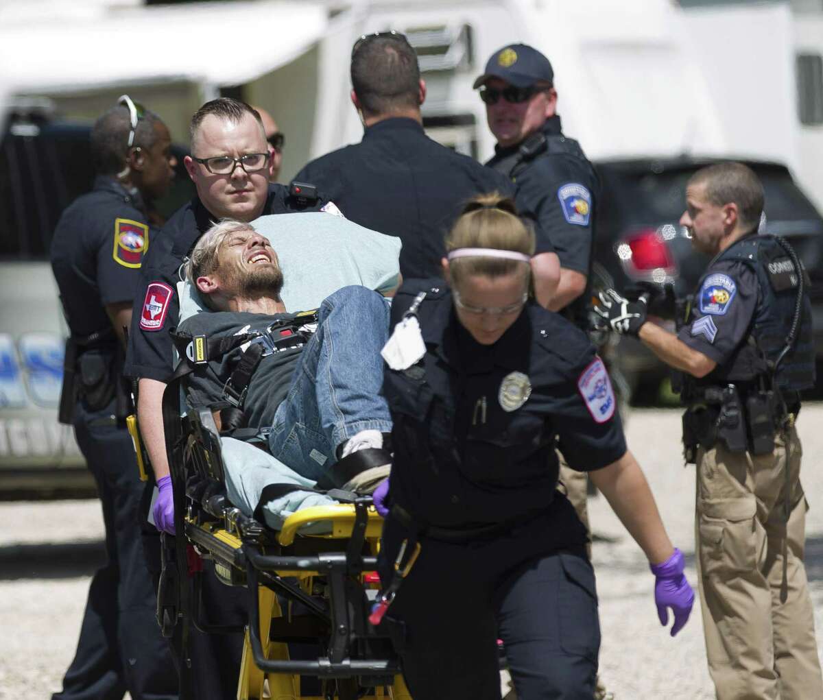 The suspect, Forest Hugh Olive, is transported by Montgomery County Hospital District paramedics at the scene where a car chase ended and two suspects were held at gunpoint by law enforcement at Omega Farms RV Park outside of Willis city limits on Wednesday, Aug. 15, 2018, in Conroe. The second suspect was later released with no charges filed against him.