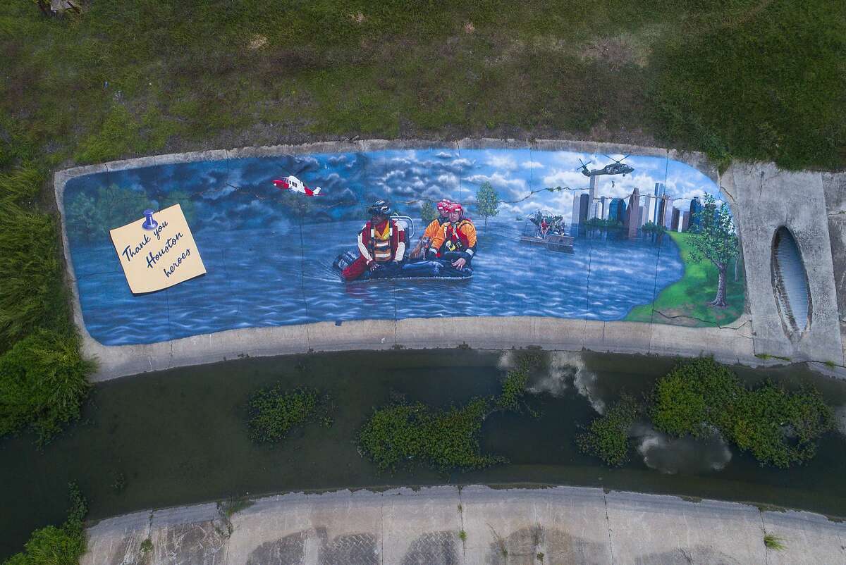 PHOTOS: Harvey then and now  A 100-foot-long, 20-foot-high mural is unveiled along a drainage canal in the Westchase District of Houston,Thursday, Aug. 16, 2018. The mural, painted by Houston muralist Larry Crawford, depicts "Harvey Heroes" -first responders including firefighters, police officers, U.S. Coast Guard and the Cajun Navy - that helped Houstonians after flooding from Hurricane Harvey. >>> See how things look in Houston one year after the catastrophic floods 