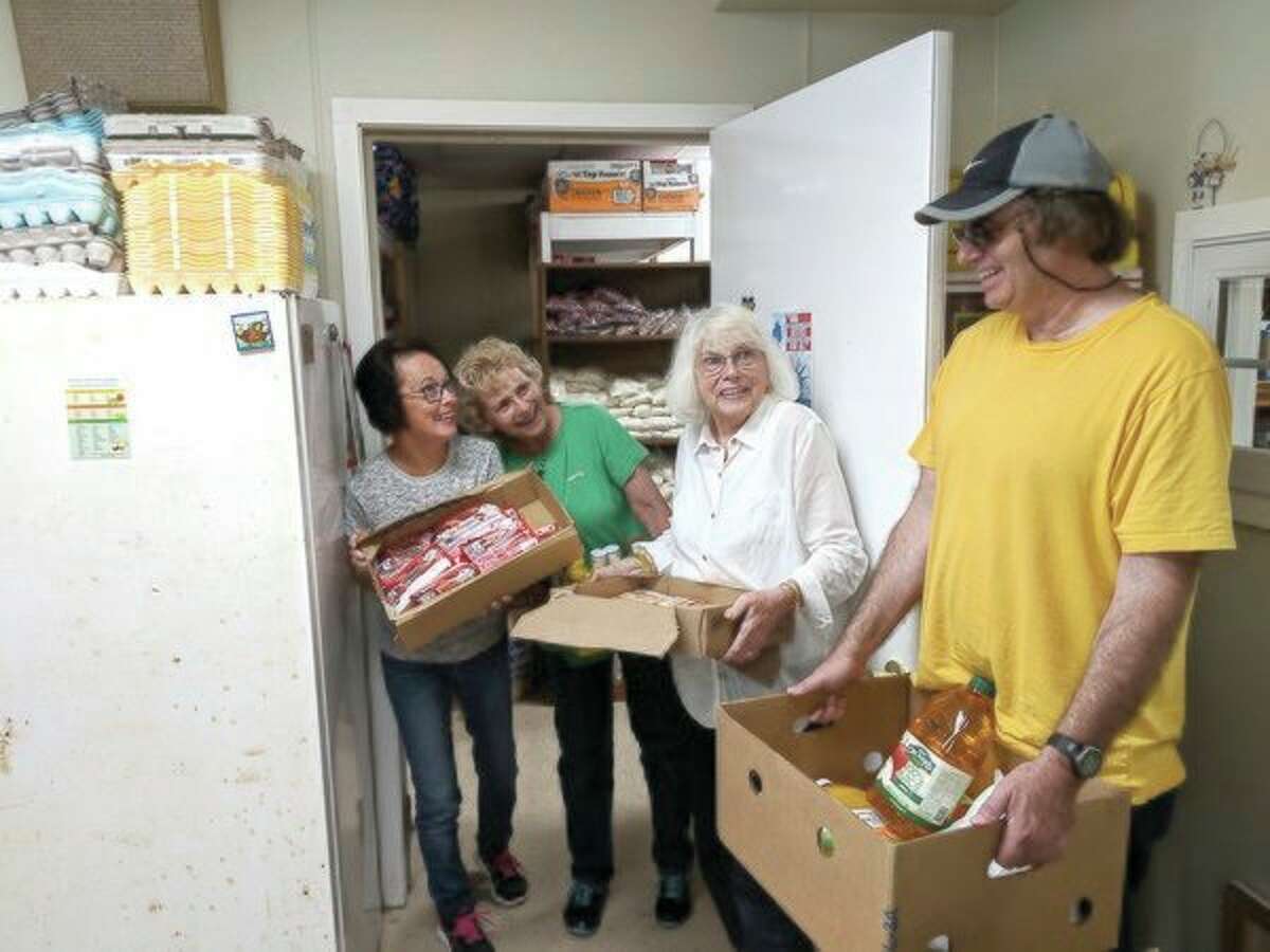 Hauling in nearly 200 pounds of food to the Beaverton Helping Hands Mission are director Becky Cook, mission volunteer Bev Whitmer, Nancy Wallace and William Wallace Jr. (Tereasa Nims/For the Daily News)