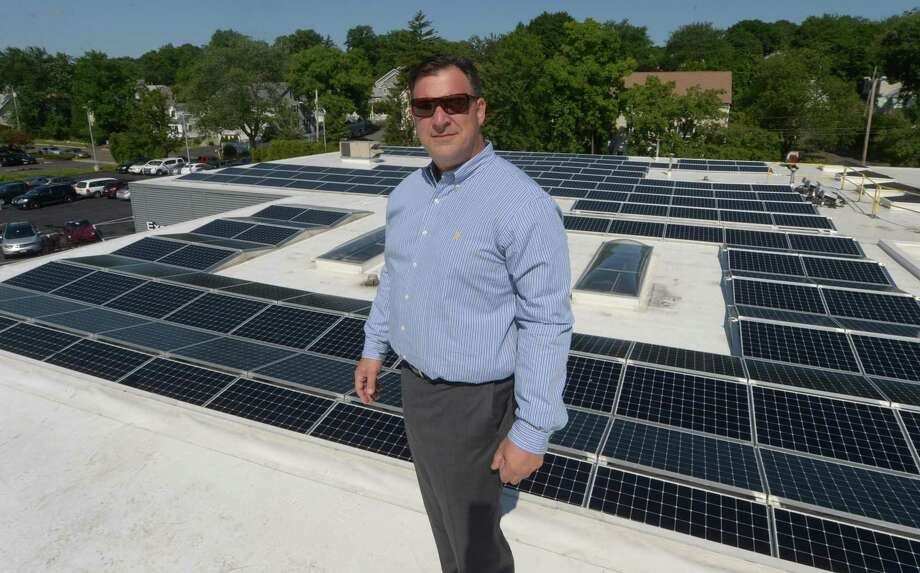 Gregg Miller, co-owner of the Miller Nissan dealership stands in front of the new solar-energy array on the dealership’s roof at 930 Kings Highway East in Fairfield, Conn., on July 18, 2018. Photo: Erik Trautmann / Hearst Connecticut Media / Norwalk Hour