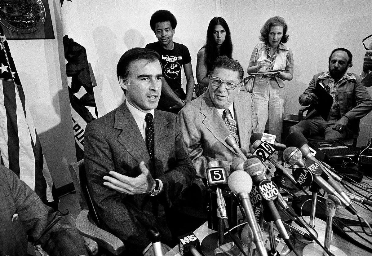** ADVANCE FOR USE SUNDAY, JUNE 1 - FILE ** California Gov. Jerry Brown gestures as tax reformer and executive director of the California Apartment Owners' Association Howard Jarvis, second from right, and reporters look on during a news conference in Los Angeles, July 19, 1978. Proposition 13, the maverick 1978 tax-slashing measure that saved California homeowners billions of dollars and inspired a nationwide revolt against higher taxes, marks its 25th anniversary June 6 in the state that it changed in profound ways. (AP Photo/Robbins, File)