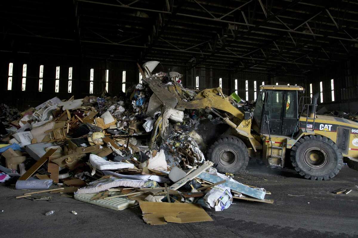 A large pile of garbage gets condensed by a front loader at the transfer station on Harborview Avenue on Thursday. Many recyclables once discarded at Katrina Mygatt Recycling Center now are being brought to the dump for sorting.