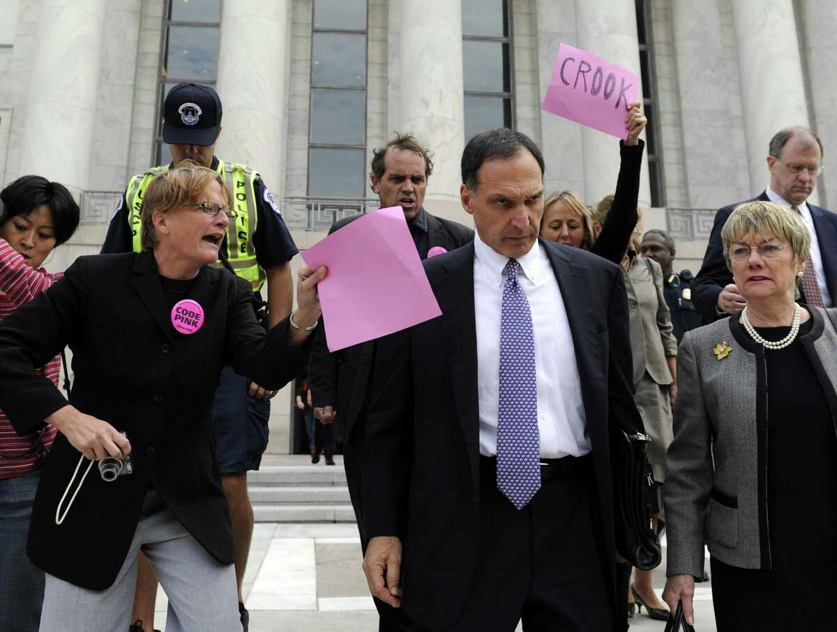 Former Lehman Brothers CEO and Greenwich resident Richard Fuld Jr. is heckled in October 2008 by protesters in Washington, D.C., after testifying before the House Oversight and Government Reform Committee on the collapse of Lehman Brothers. (AP Photo/Susan Walsh)