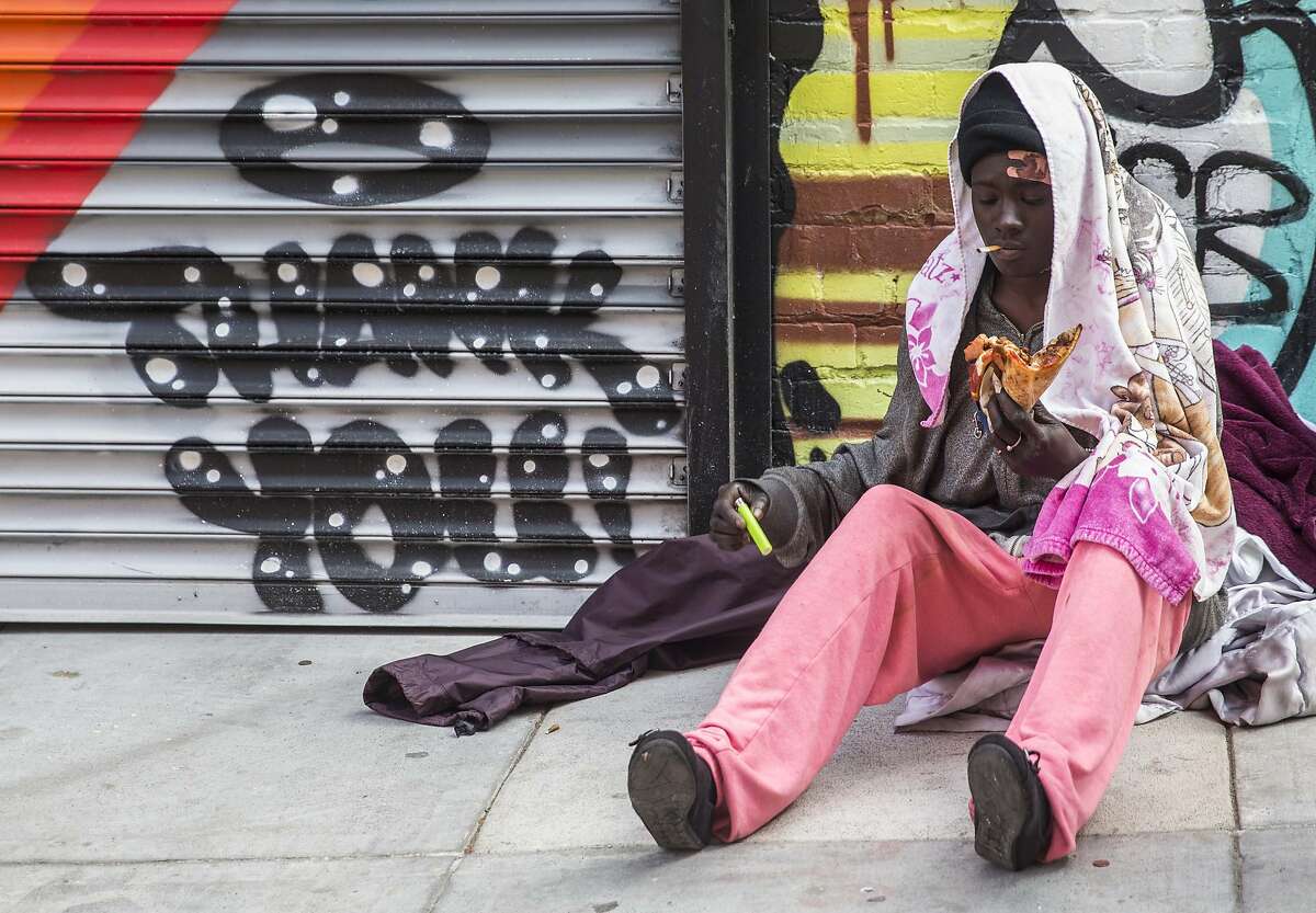 Jennice Mitchell, a homeless woman, eats a slice of pizza from Nob Hill Pizza & Shawarma given to her by Andrea Carla Michaels while she sits in an alley in the Nob Hill district of San Francisco, Calif. Tuesday, Aug. 14, 2018.