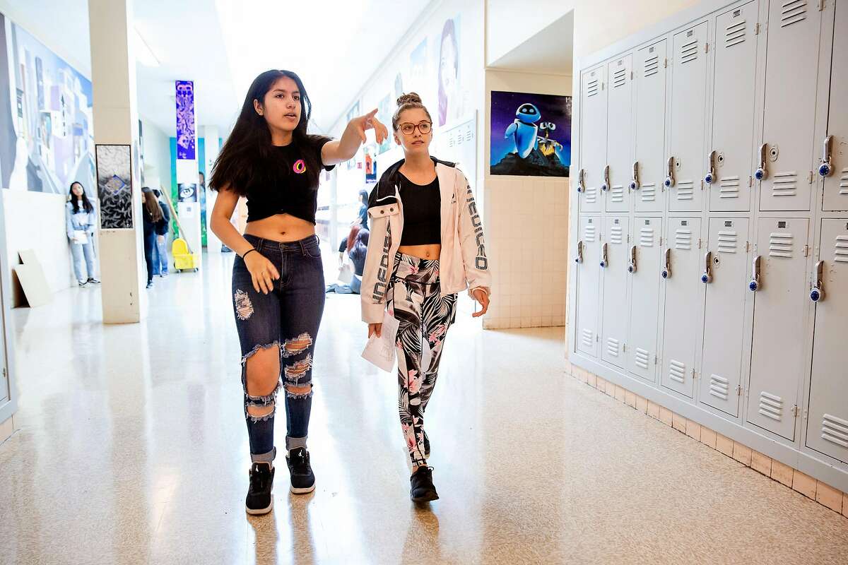 Sofia Valdez (left), 15, and Sophia Portolese, 15, walk the halls of the foreign language building at Alameda High School in Alameda, Calif. on Tuesday, August 14, 2018. Both girls are wearing clothing that would have previously not been allowed under the schools dress code policy. However with new changes to the policy, ripped jeans and midriff tops are just a few of the articles of clothing now allowed.