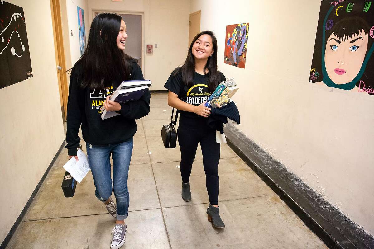 Kristen Wong (right), 14, and Chelsea Chan, 14, walk through the hallways at Alameda High School in Alameda, Calif. on Tuesday, August 14, 2018.