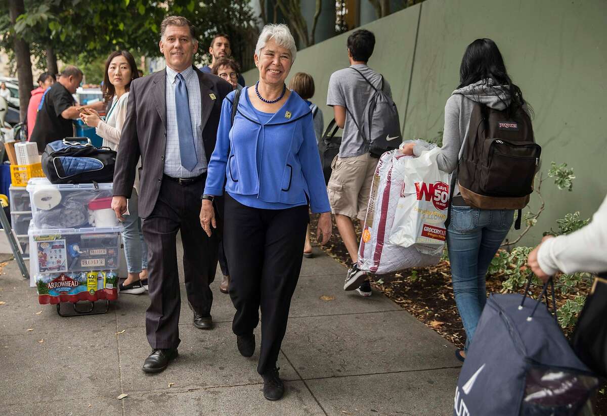 UC Berkeley Chancellor Carol Christ walks by new students and parents as they haul belongings into the Unit 1 Residential Hall during move-in day at the dorms in Berkeley, Calif. Tuesday, Aug. 14, 2018.