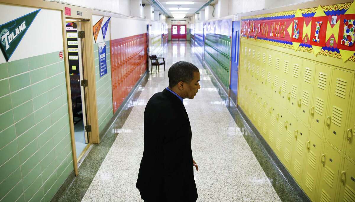 In this August 2017 file photo, then-Kashmere Gardens Elementary School principal Reginald Bush walks through the halls of the school. Bush now leads Kashmere High School. ( Michael Ciaglo / Houston Chronicle )