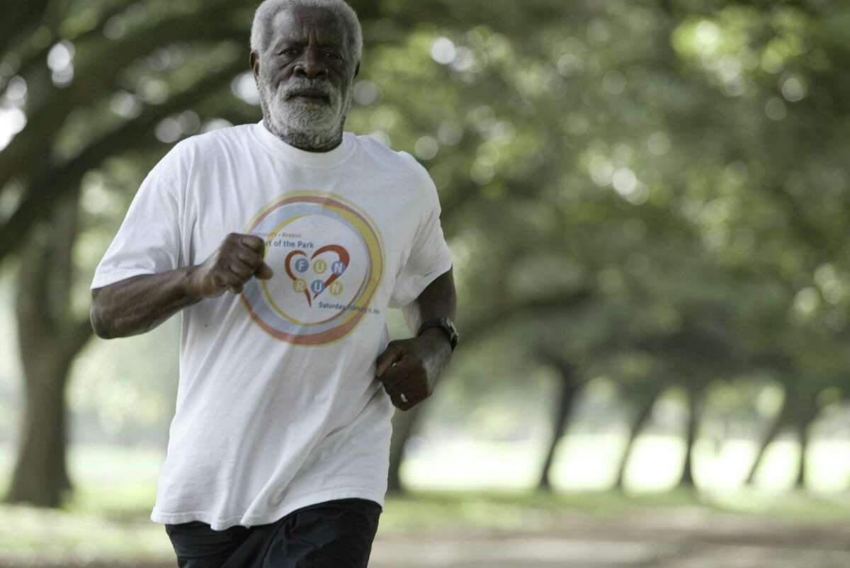 Marvin Taylor, 78, poses for pictures in a running path in Hermann Park, 07/17/03. Taylor is credited with advocating running paths in Hermann Park and Macgregor Park. (Buster Dean / Chronicle)