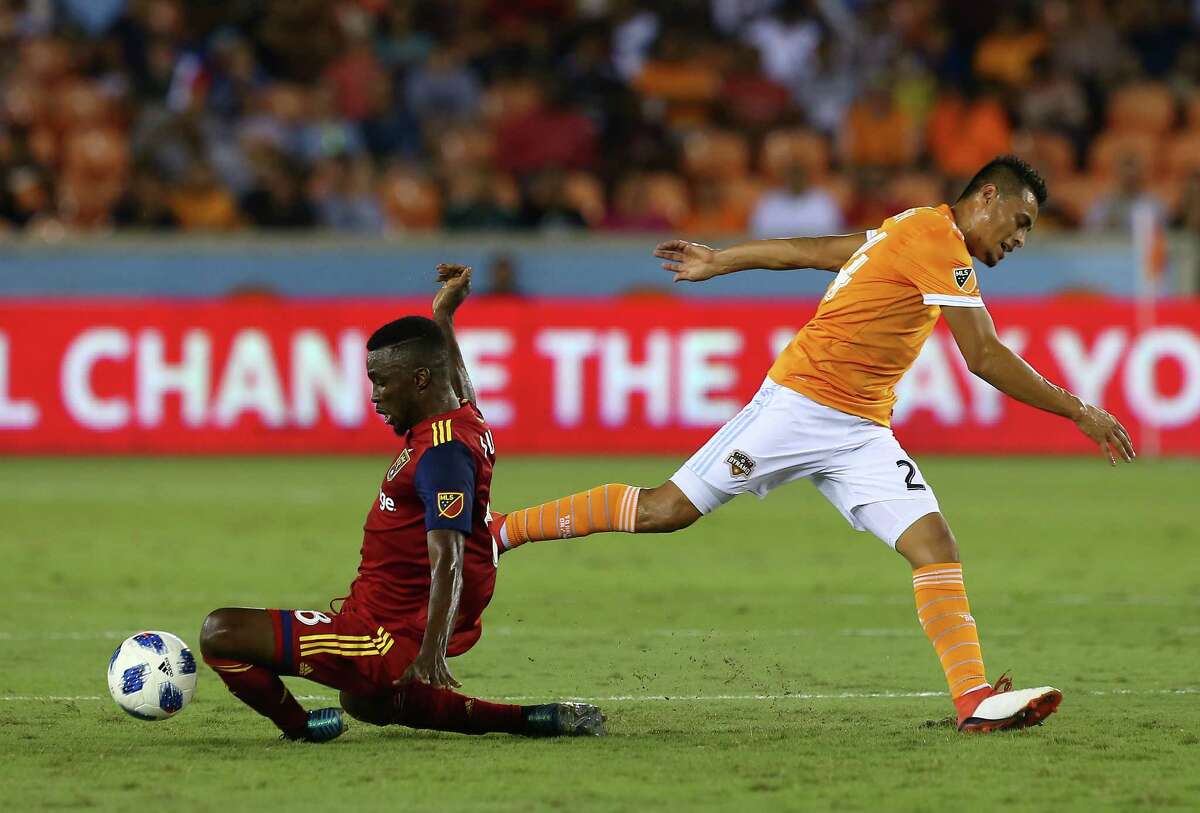 Real Salt Lake midfielder Stephen Sunny Sunday (8) takes the ball away from Houston Dynamo midfielder Darwin Ceren (24) during the first half of an MLS match at BBVA Compass Stadium Saturday, Aug. 18, 2018, in Houston.