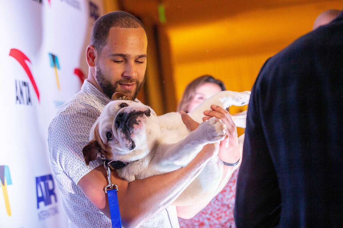 Mychel Thompson with dog Rocco at the red carpet for the Thompson Family Foundation at Hotel Vitale, Saturday, Aug. 18, 2018, in San Francisco, Calif.