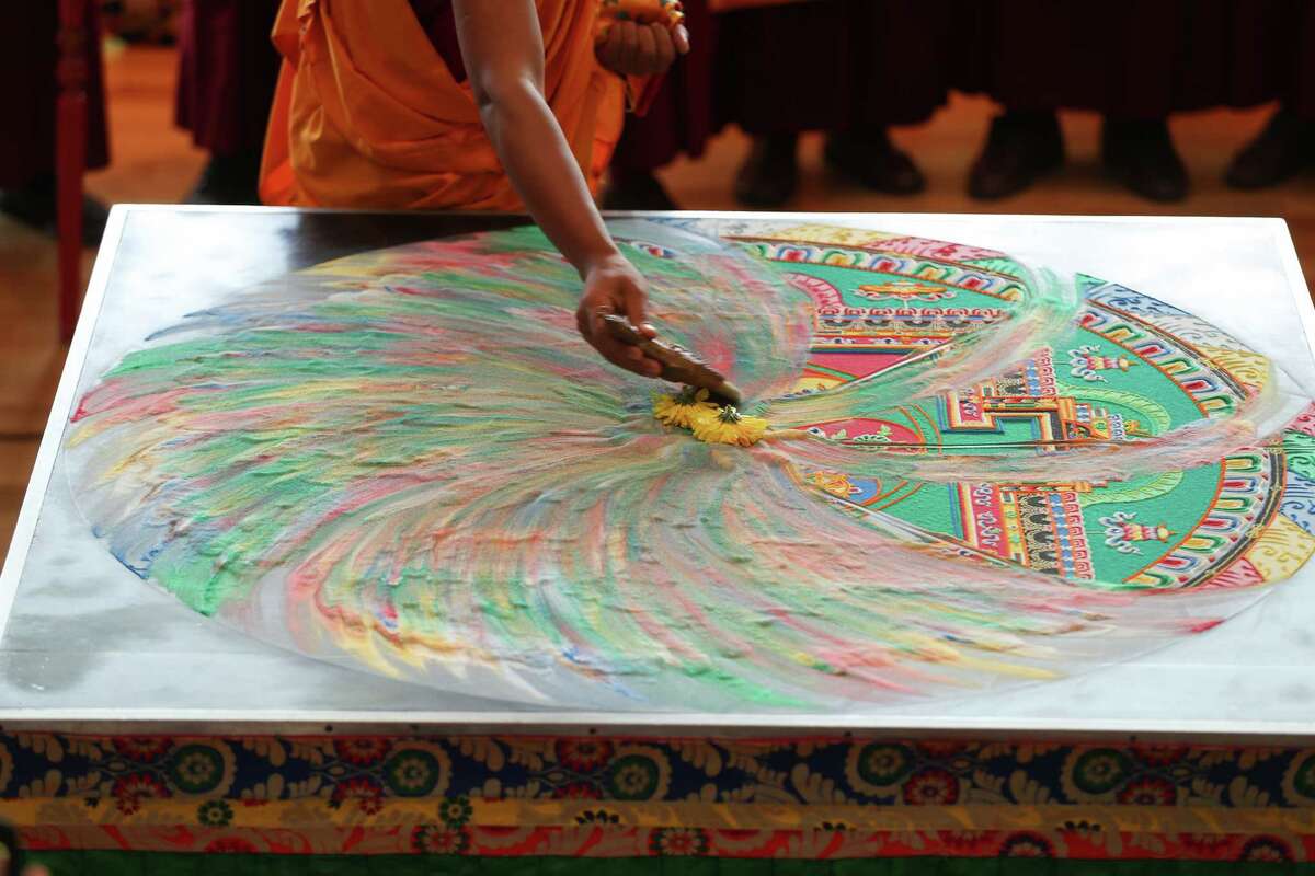 Tibetan Buddhist monks dismantle a mandala at Asia Society Texas Center
