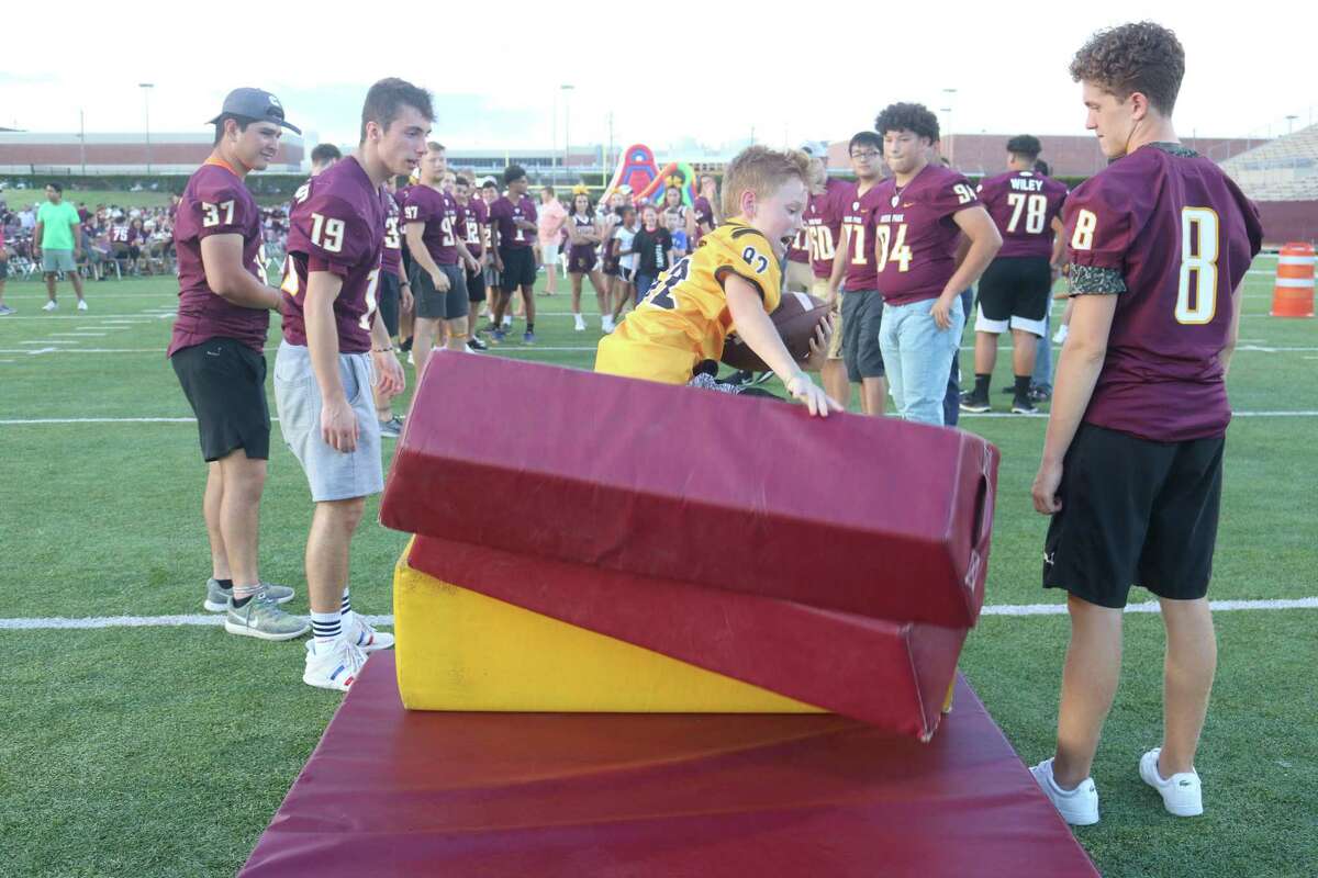 Diving into a stack of blocking pads proved popular for the kids during the Kickoff Party Saturday night.