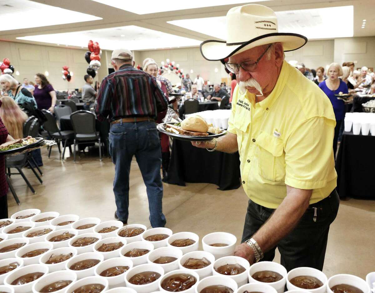 Attendant Walt Jahnke gets some tea during with dinner during the MCFA Appreciation Party and Casino Night held at the Lone Star Convention and Expo Saturday, Aug. 18, 2018 in Conroe, Texas.