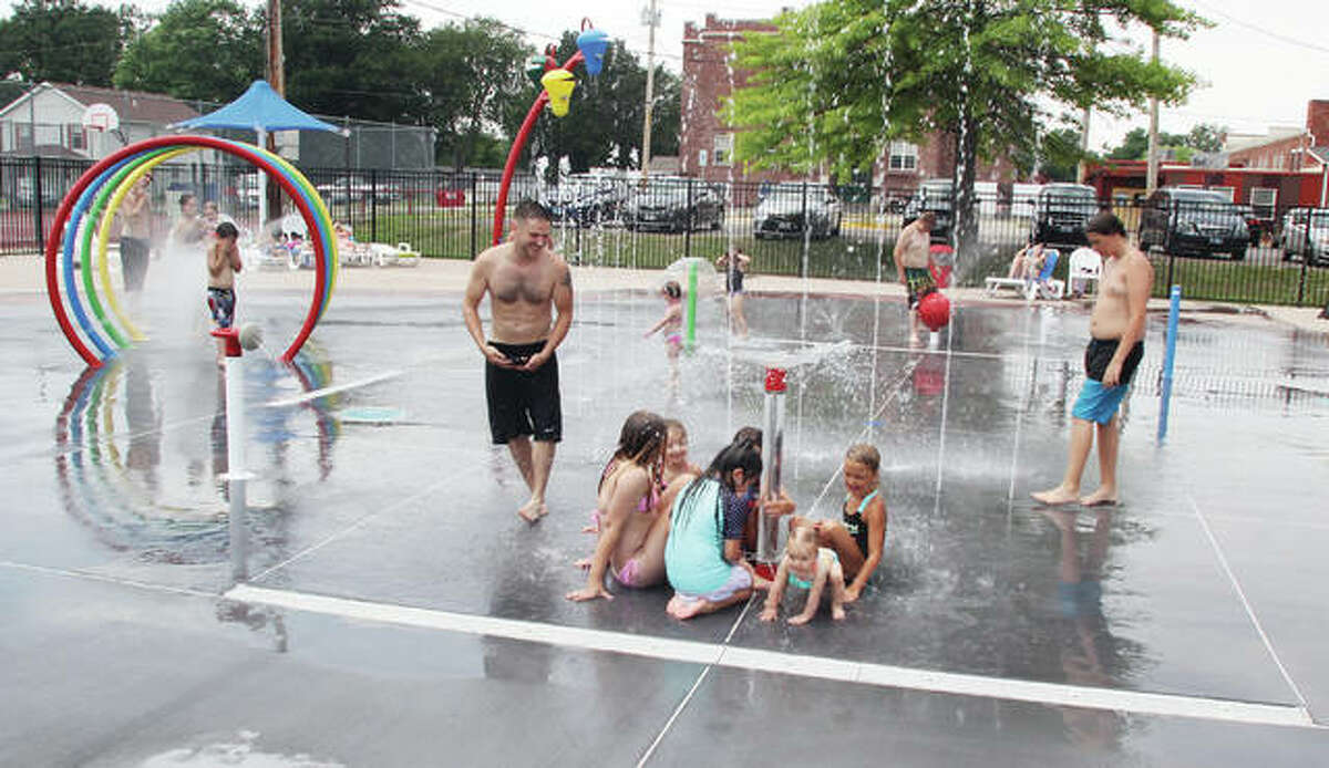 In this photo from June, Children and adults play in the heat at the Bethalto splash pad in Central Park. The new attraction replaced the village’s public swimming pool, and Mayor Alan Winslow said recently that the pad was a success in its first year.
